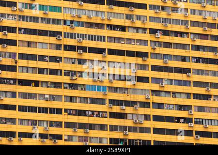 Riesiger überfüllter Wohnblock in Singapur, wiederholte Fenster in Form eines unendlichen Musters Stockfoto