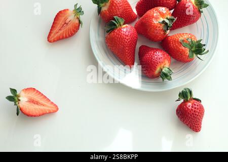 Gruppe von geschnittenen Erdbeeren aus dem Garten zu Hause auf Teller. Sonnentag. Umweltfreundliches reines Naturprodukt. Stockfoto