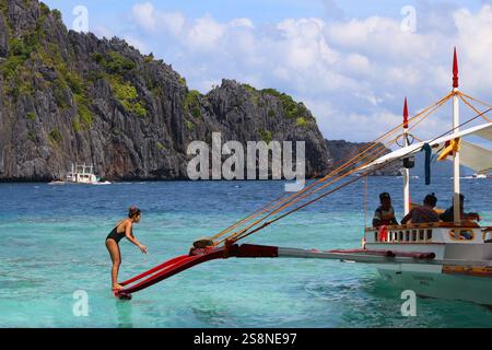 PALAWAN, PHILIPPINEN - 1. DEZEMBER 2017: Die Menschen genießen eine Inselhüpftour in einem Outrigger bangka Boot in Palawan, Philippinen. Stockfoto