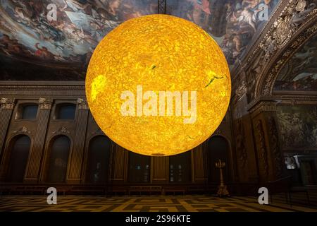 London, Großbritannien. Januar 2025. „Helios“, eine neue Kunstinstallation der Sonne von Luke Jerram in der Painted Hall, Old Royal Naval College, Greenwich. Im Maßstab von 1:200 Millionen kombiniert die innen beleuchtete sieben Meter große Skulptur Sonnenbilder, Licht und Ton, um die komplizierten Details der Sonne hervorzuheben. Benannt nach dem antiken griechischen und römischen Sonnengott, symbolisch für Zeit und Leben, würdigt „Helios“ den tiefgreifenden Einfluss der Sonne auf die menschliche Geschichte und Kultur. Guy Corbishley/Alamy Live News Stockfoto