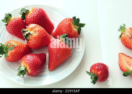 Gruppe von geschnittenen Erdbeeren aus dem Garten zu Hause auf Teller. Sonnentag. Umweltfreundliches reines Naturprodukt. Stockfoto