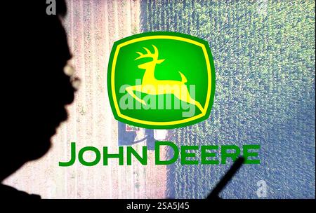 In dieser Abbildung wird das Logo von Deere & Company im Hintergrund angezeigt. Stockfoto
