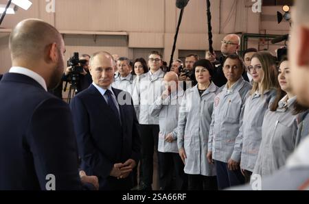 Togliatti, Russland. Januar 2025. Der russische Präsident Wladimir Putin, Zentrum, hört den Gouverneur der Region Samara, Wjatschow Fedorishchev, den er verlassen hat, während eines Treffens mit Mitarbeitern nach einem Rundgang durch die Automobilproduktion im Werk Tolyatti am 28. Januar 2025 in Togliatti, Oblast Samara, Russland. Quelle: Vyacheslav Prokofyev/Kreml Pool/Alamy Live News Stockfoto