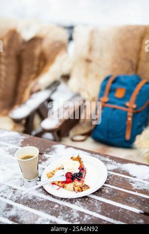 Köstliche Crepes mit Beeren und Schlagsahne, die an verschneiten Wintertagen im Freien serviert werden Stockfoto