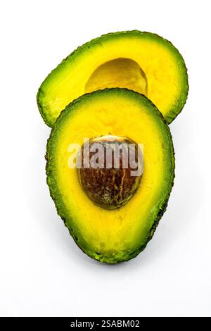 Nahaufnahme einer Reifen Avocado, die in zwei Hälften geschnitten wurde, isoliert auf weißem Hintergrund. Stockfoto