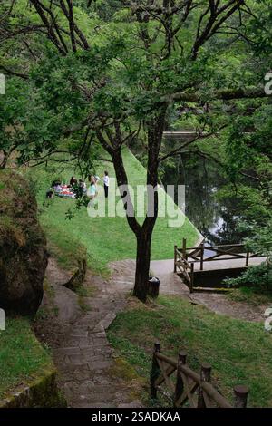 Eine Familie hat ein Picknick im Erholungsbereich des Pools ​​the Sete Muiños in Guitiriz. Route 2 Sete Muiños. Park, Garten. Stockfoto