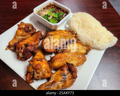 Knusprige Thai Chicken Wings mit Sticky Rice und Dipping Sauce Eye Level View Stockfoto