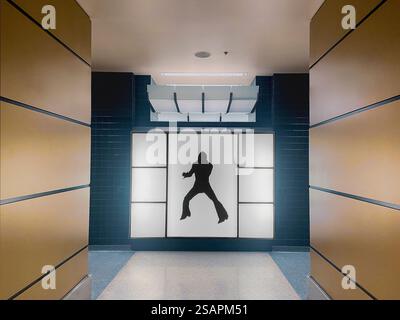 Eingang des öffentlichen Badezimmers für Männer mit Silhouette von Elvis Presley an der Wand Stockfoto