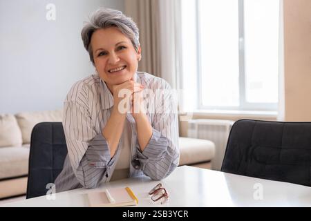 Porträt einer schönen, gepflegten Rentnerin im Alter. Ältere Dame mit grauem Haar sitzt Stockfoto