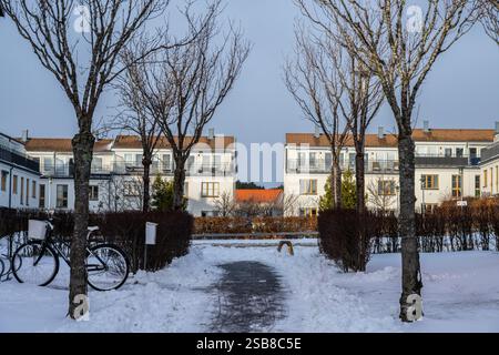 Schneebedeckter Wohnweg mit Fahrrädern im Winter Stockfoto