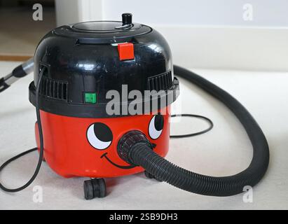 Sehr alter Staubsauger Henry mit lustigem Design im Innenraum. Stockfoto