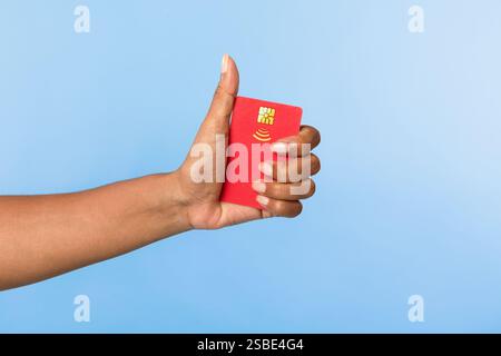 Zugeschnittene Ansicht einer Afroamerikanerin, die rote Kreditkarte hält und den Daumen nach oben zeigt Stockfoto