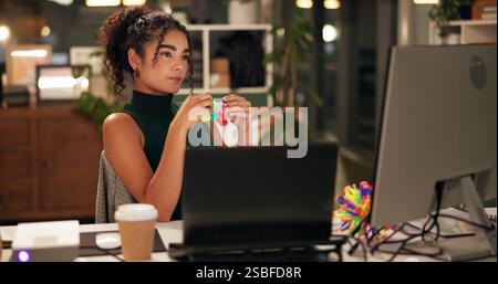 Geschäftsfrau, Computer und Thinking mit popit-Spielzeug, Kreativagentur und Ideen für Brainstorming bei Nacht. Mädchen, Markenberater oder Laptop mit mehreren Bildschirmen Stockfoto