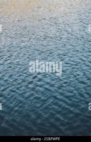 Goldene Reflexionen über plätscherndes Wasser in der Abenddämmerung Stockfoto