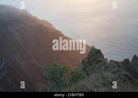 Atemberaubender Sonnenaufgang über der Na Pali Küste, Kauai. Dramatische Klippen treffen auf den Pazifik und schaffen eine atemberaubende tropische Landschaft. Stockfoto