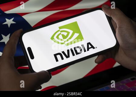 In dieser Fotoabbildung wird das Logo der Nvidia Corporation am 30. Januar 2025 auf einem iPhone-Bildschirm vor der amerikanischen Flagge in Guwahati, Ind, angezeigt Stockfoto