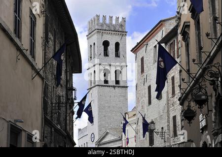 Altstadtallee mit Fahnen dekoriert, Kirchturm der Kirche Santa Maria sopra Minerva, Stadtzentrum, Altstadt, Assisi, Italien, mittelalterlicher Turm in A n Stockfoto