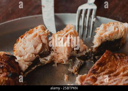 Nahaufnahme von blättrigem gebackenem Lachs auf einem Teller Stockfoto