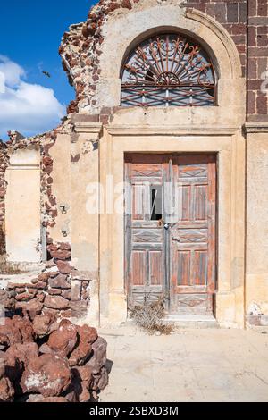 Kaputte Eingangstür in einem Haus, das vom Erdbeben von 1956 in Oia, Santorin, Griechenland stammt Stockfoto