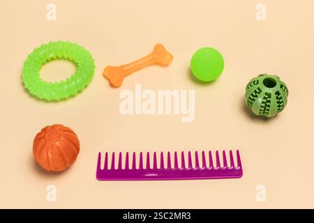Haustierzubehör und verspielte Gegenstände wie Kamm, Spielzeugkugeln, Gummiring und Kauknochen für Hunde. Stockfoto