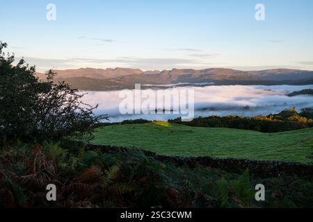 Wolkenumkehr über dem Lake Windermere an einem wunderschönen Herbstmorgen im Lake District National Park, Cumbria, England. Stockfoto