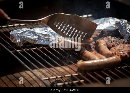 BBQ-Forelle, Sauages und Burger. Forelle in Folie. Sommerparty. Stockfoto