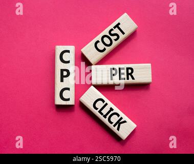 CPC – Symbol „Kosten pro Klick“. Konzeptwort AGM auf Holzwürfeln. Schöner roter Hintergrund. Business- und NGM-Konzept. Kopierbereich. Stockfoto