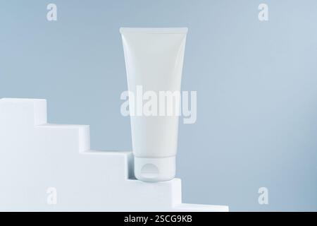 Mockup-Vorlage für weiße Röhrencreme oder Serum auf weißen Treppen Podium Heldenansicht Stockfoto