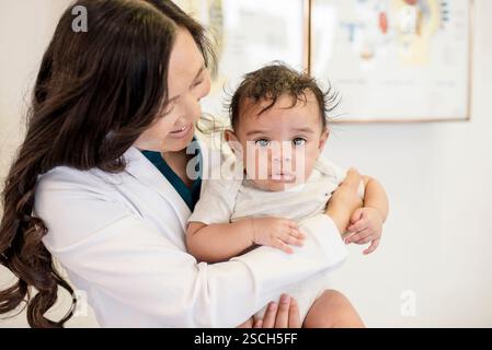 Nahaufnahme eines Arztes, der das Baby hält Stockfoto