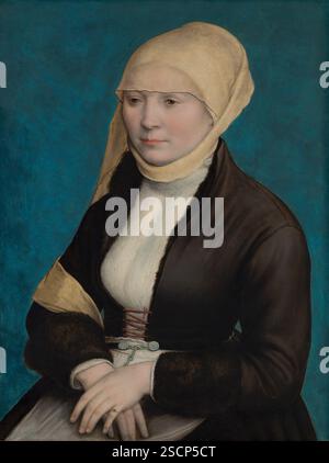 Porträt einer süddeutschen Frau. Über einer Bluse mit feinem Plisseedetail und Kragen trägt diese unbekannte Frau eine Jacke mit Fellfutter (A &#x2018;B&#xfc;rstlein&#x2019;), die sie mit einer roten Kordelschnüre geschlossen hat. Auf dem Kopf trägt sie eine eher altmodische Mütze und einen Schleier, wie sie von Stadträtern in Süddeutschland getragen werden. Ihr helles Gesicht hebt sich gut vom blauen Hintergrund ab. Stockfoto