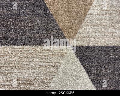Nahaufnahme der Teppichtextur in zufälliger Schmutz-, Dreieck-, Streifen- und Grunge-Textur. In Braun, weiß, Beige und Grau. Abstraktes Zufallsmuster Stockfoto