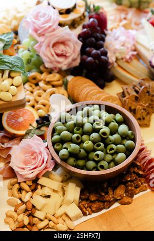 Ein lebhaftes Angebot an Oliven, Käse, Früchten und Nüssen bietet kulinarische Kunst für ein festliches Treffen. Stockfoto