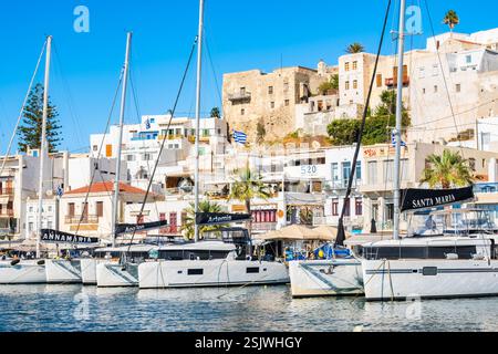 INSEL NAXOS, GRIECHENLAND - 25. September 2024: Segelboote vor Anker im Hafen von Naxos mit Altstadtgebäuden von Chora im Hintergrund. Stockfoto