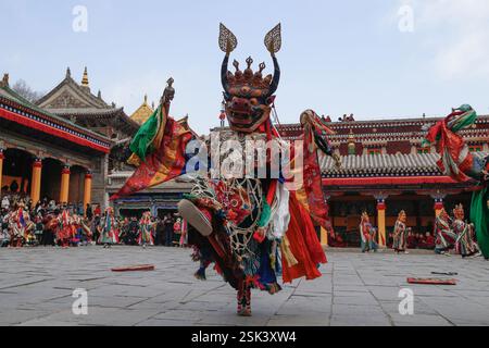 Xining, China. 11. Februar 2025. Ein maskierter buddhistischer Mönch führt am 11. Februar 2025 in Xining, Provinz Qinghai, den Cham-Tanz auf, um für Frieden und Wohlstand zu beten. Der Cham-Tanz wurde 2006 als eines der nationalen immateriellen Kulturgüter aufgeführt. Quelle: Ma Mingyan/China News Service/Alamy Live News Stockfoto
