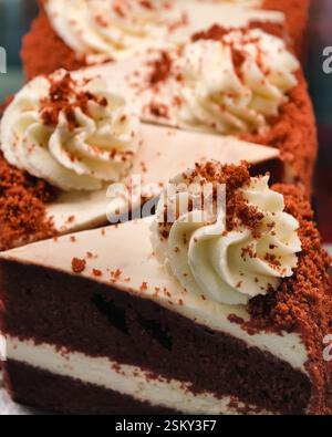 Leckerer und sehr leckerer Schokoladenkuchen mit großen weißen Cremeblüten und Schokolade. Schokoladenkuchen mit weißer Creme Stockfoto