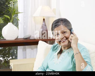 Alte Dame hören auf mobile Herr #702S Stockfoto