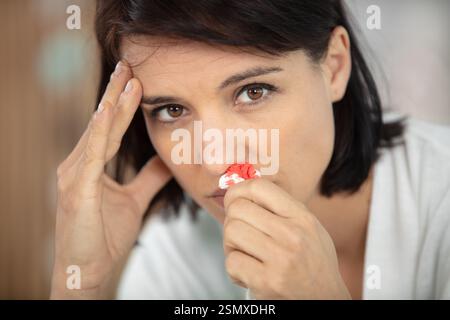 asiatische Frauen in Satin-Nachtwäsche mit Nasenblut Stockfoto