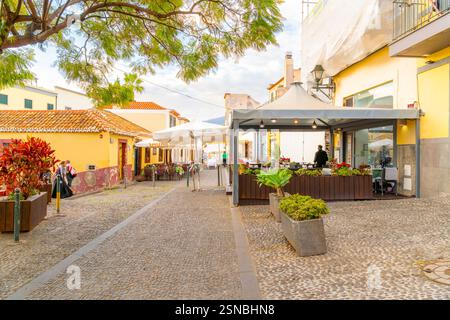 Straßencafés an der Rua de Santa Maria, der wichtigsten kopfsteingepflasterten engen Straße durch die mittelalterliche Altstadt von Funchal, Portugal, auf Madeira Island. Stockfoto