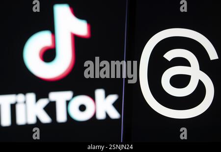 Das Threads-Logo wird auf einem Smartphone und das TikTok-Logo im Hintergrund angezeigt Stockfoto