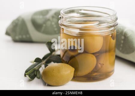 Eingelegte Oliven und Olivenzweig Stockfoto