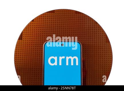 ARM Holdings Logo auf dem Smartphone und dem Halbleiterwafer mit Chips. Anschaulich für einen neuen Chip von ARM Company. Stafford, Vereinigtes Königreich, F Stockfoto