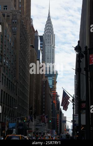 New Yorks geschäftige Midtown: Art-Deco-Details zieren das Chrysler Building, ein majestätisches Wahrzeichen an einer geschäftigen Straße. Stockfoto