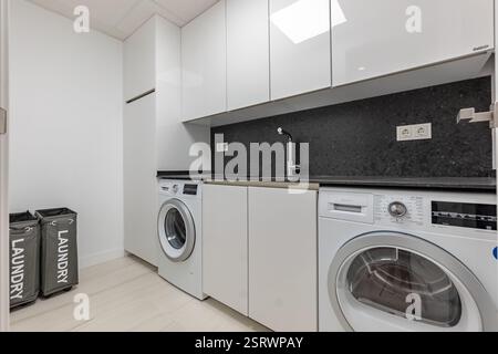 Ein Bild von einem Waschbereich mit Waschmaschine und Trockner in Luxus-Apartment-Immobilien Stockfoto