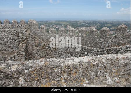 Mittelalterliche Burg auf einem Hügel mit Blick auf üppiges Grün. Eine Festung der Geschichte, die Portugals Erbe in Sintra bewacht. Oder ein Steinlabyrinth, Stockfoto