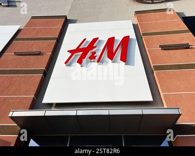 Lemberg, Ukraine - 16. Februar 2025: Rotes H- und M-Logo auf einer weißen Tafel an einer braunen Fassade des Gebäudes. Stockfoto