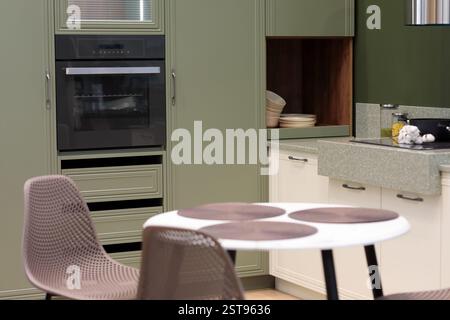 Moderne Wohnküche mit Esstisch und Stühlen. Selektiver Fokus. Stockfoto