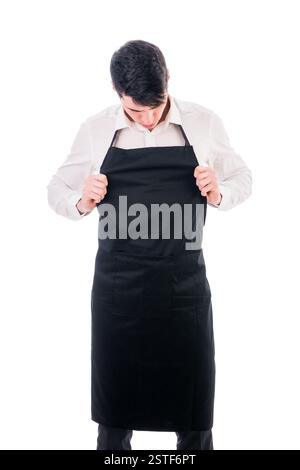 Jungkoch oder Kellner tragen schwarze Schürze isoliert Stockfoto