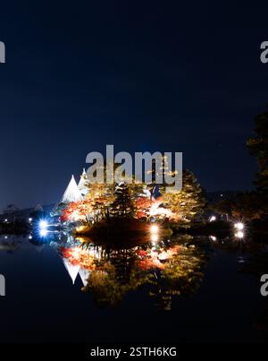 Ein ruhiger nächtlicher Blick auf den Kenrokuen Garden in Kanazawa, beleuchtet von sanften Lichtern, zeigt die Schönheit der japanischen Landschaft unter dem Nachthimmel. Stockfoto