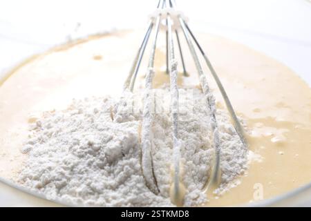 Schneebesen und eine Schüssel Teig, Nahansicht Stockfoto