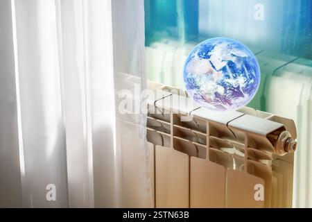 Kreative Fotocollage mit Erde auf einem Heizkörper, die die vom Menschen verursachte globale Erwärmung und den Klimawandel symbolisiert. Stockfoto